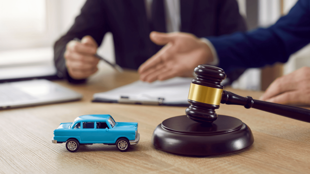 A driver and legal professional complete a commercial vehicle accident report in a law office with a truck visible outside.
