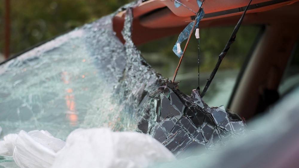 Close-up of a shattered windshield after a severe car crash