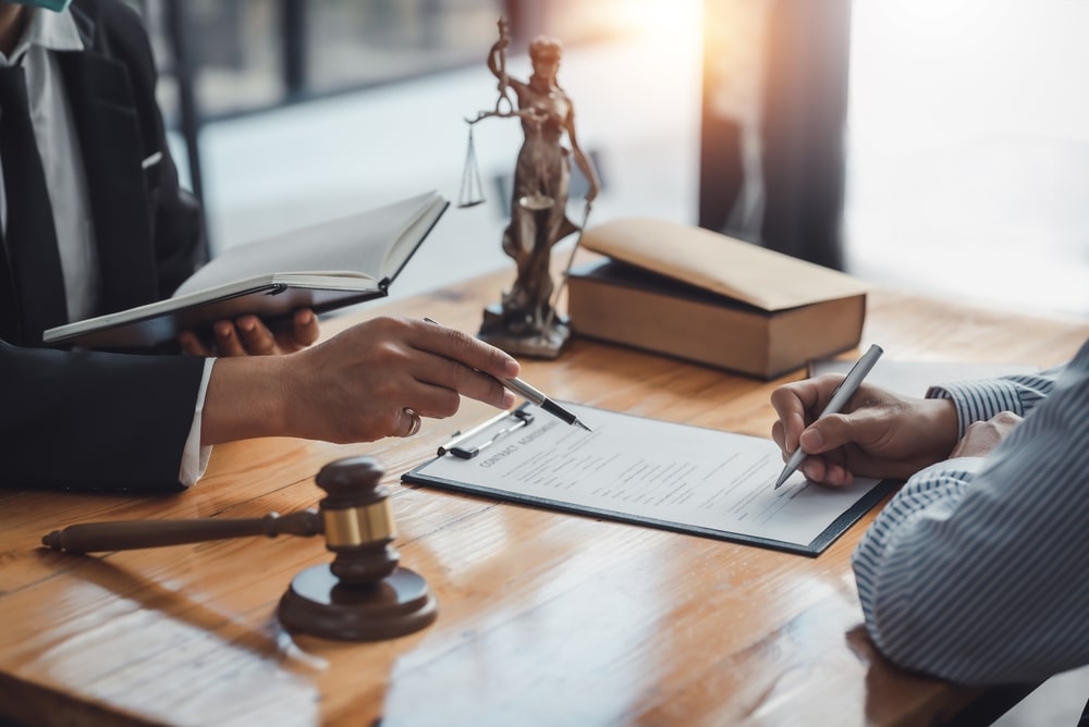 Lawyer and client reviewing legal documents on negligence