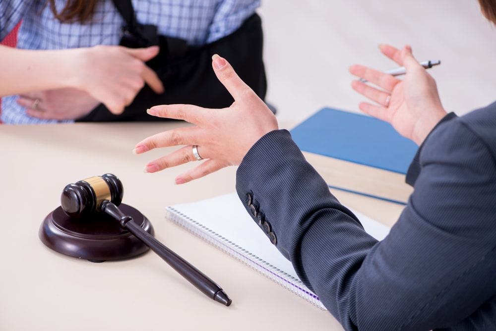 An injured person is meeting with a lawyer about a negligence claim