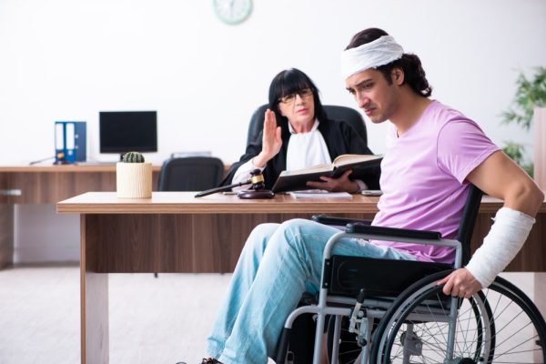 Injured man in wheelchair speaks with attorney after truck accident