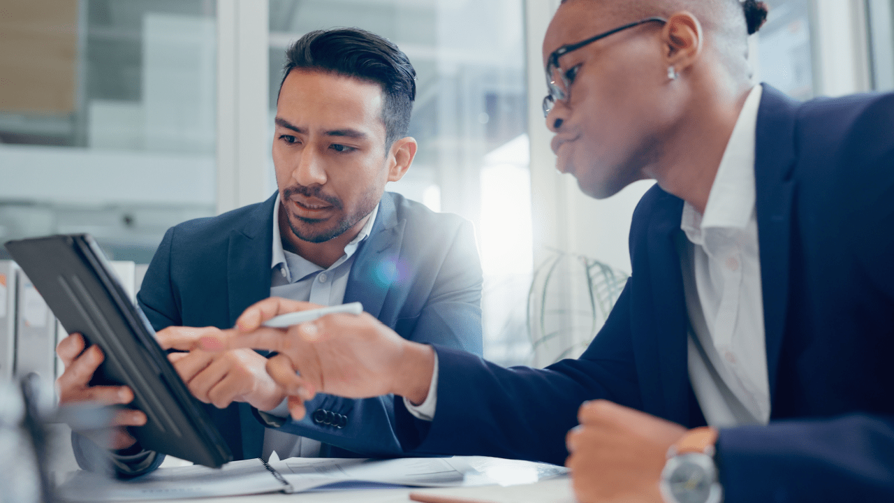Two professional men discussing how do you prove back pain from a car accident case with legal documents in modern office setting
