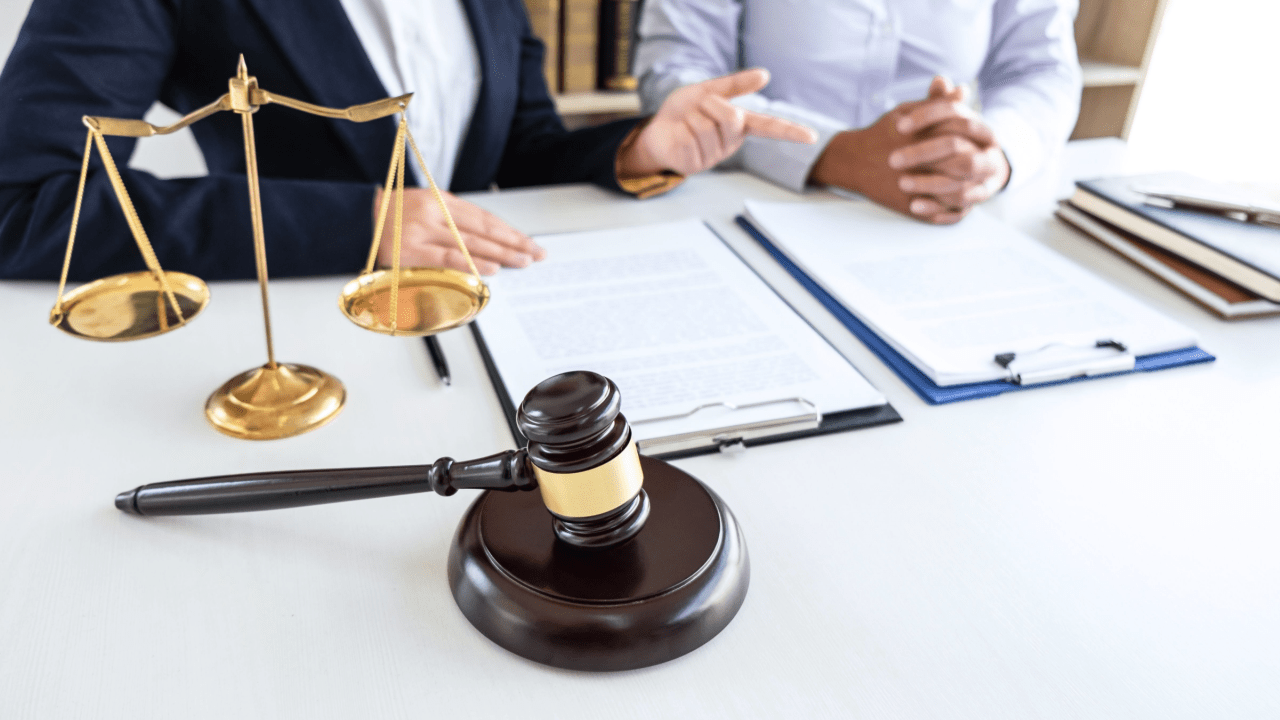 CDL accident attorneys discussing how long does an accident affect CDL with scales of justice and legal documents