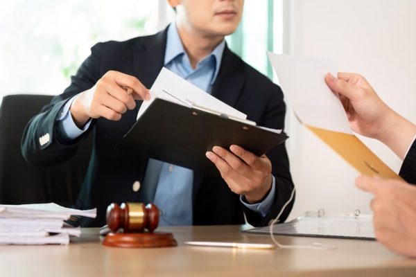 Lawyer reviewing legal documents with client during negligence case consultation