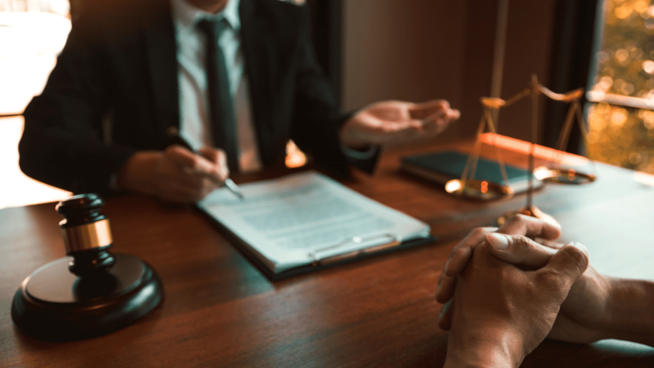 Legal professional consulting about what three things are required to prove negligence with gavel and scales of justice
