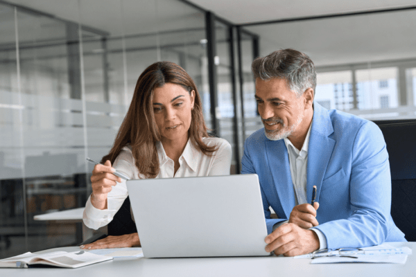 Two professionals reviewing settlement documents on how to settle an injury claim without a lawyer