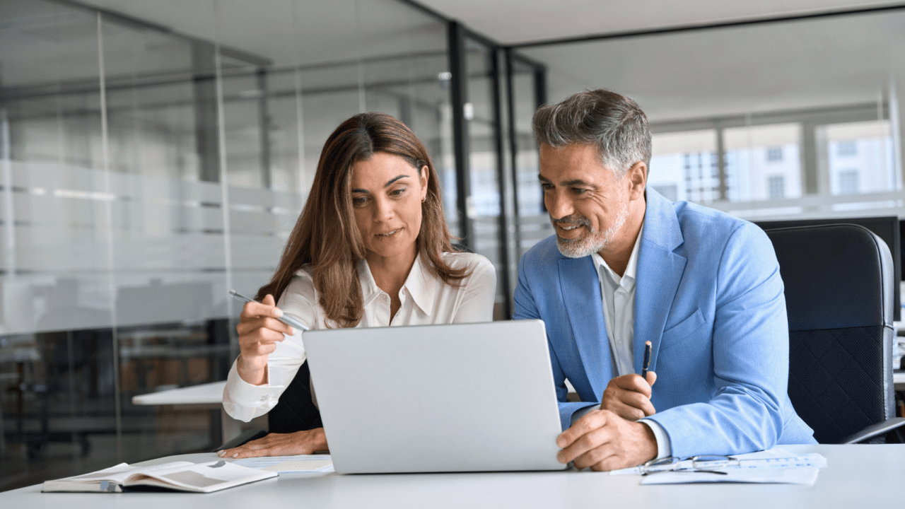 Two professionals reviewing settlement documents on how to settle an injury claim without a lawyer