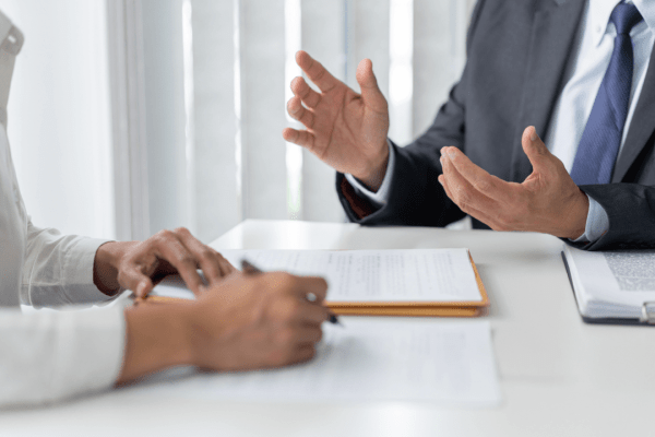 Legal consultation about can you sue a truck driver - business professionals discussing lawsuit options in modern office