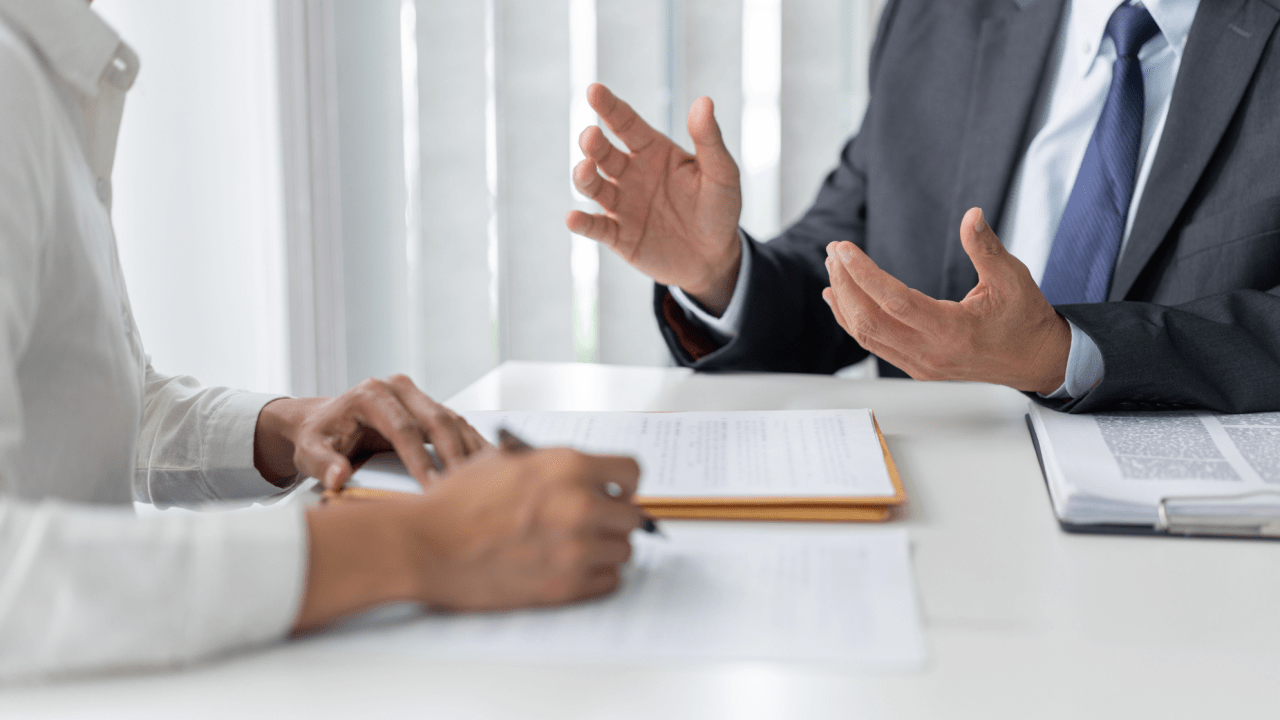 Legal consultation about can you sue a truck driver - business professionals discussing lawsuit options in modern office