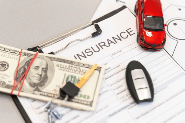 Car insurance claim documents with money and car keys showing Motor Insurance Bureau claim process timeline