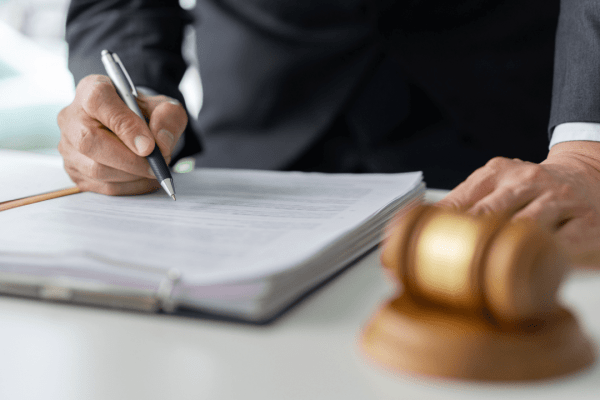 Lawyer explaining how to get the most out of an injury claim while reviewing legal documents