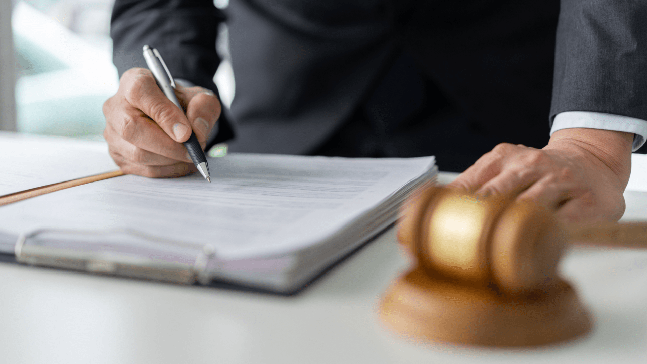 Lawyer explaining how to get the most out of an injury claim while reviewing legal documents