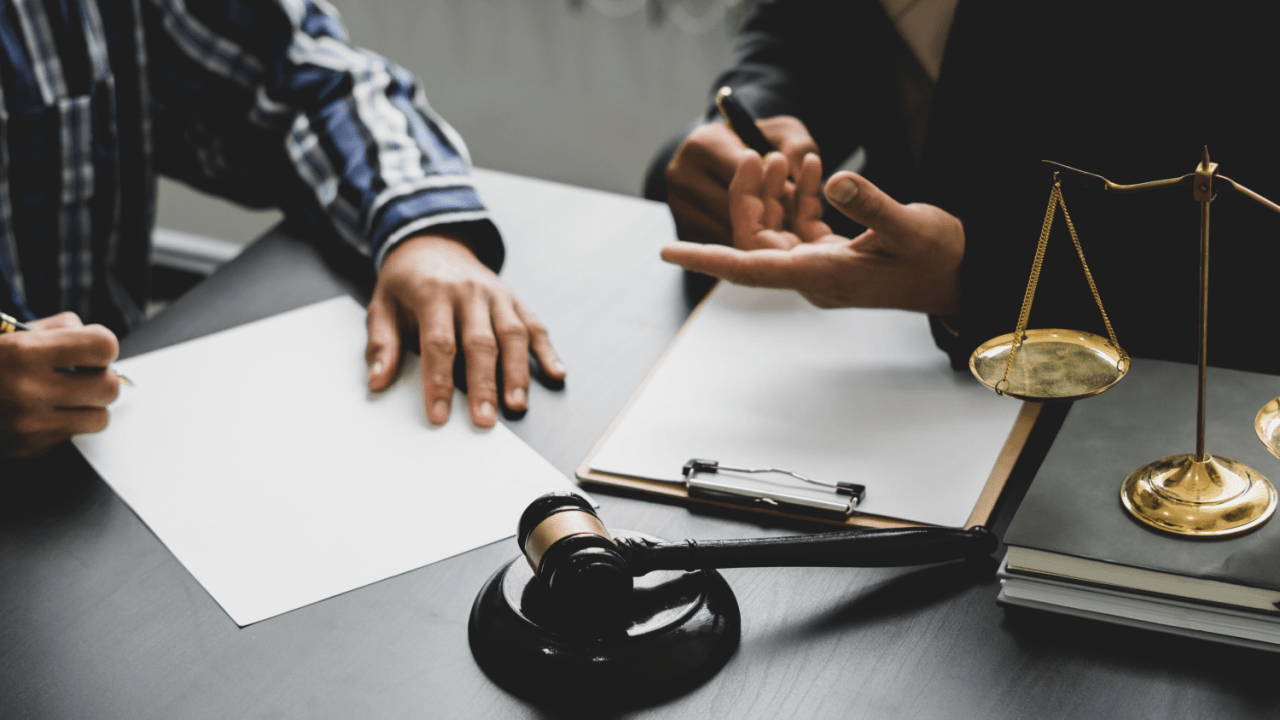 Attorney consulting with client about how much does an accident devalue a truck with legal documents and scales of justice