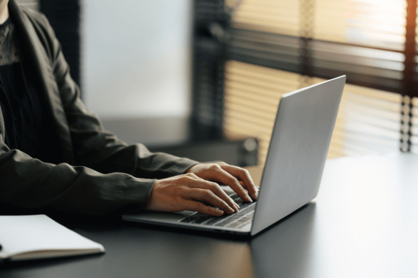 Professional attorney researching how much do accident attorneys charge for truck accidents while working on laptop computer