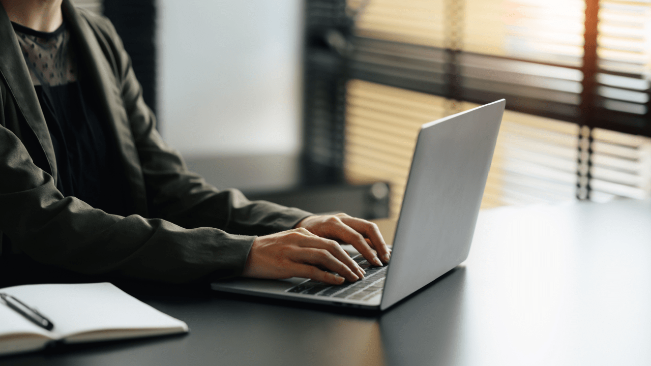 Professional attorney researching how much do accident attorneys charge for truck accidents while working on laptop computer