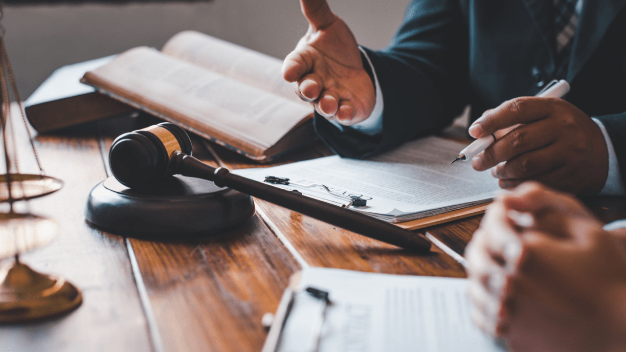 Attorney explaining how accident history affects truck resale value during legal consultation with law books and gavel