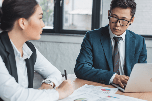 Attorney and client discussing should I settle my personal injury case decision with documents