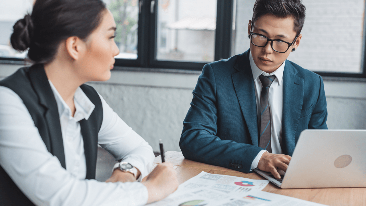 Attorney and client discussing should I settle my personal injury case decision with documents