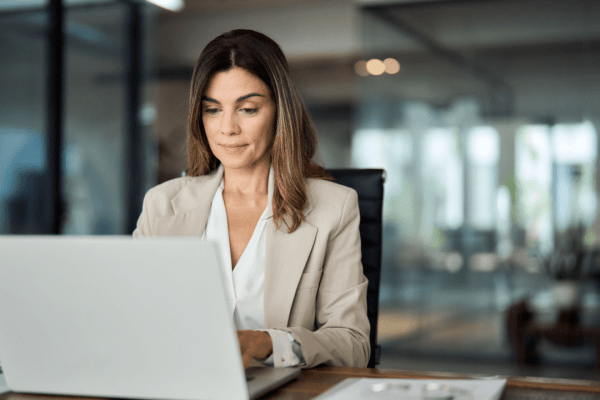 Professional woman researching what qualifies for a personal injury lawyer on laptop