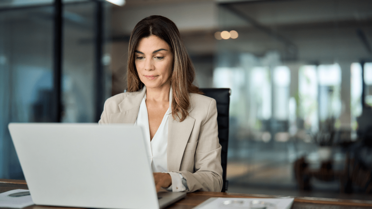 Professional woman researching what qualifies for a personal injury lawyer on laptop