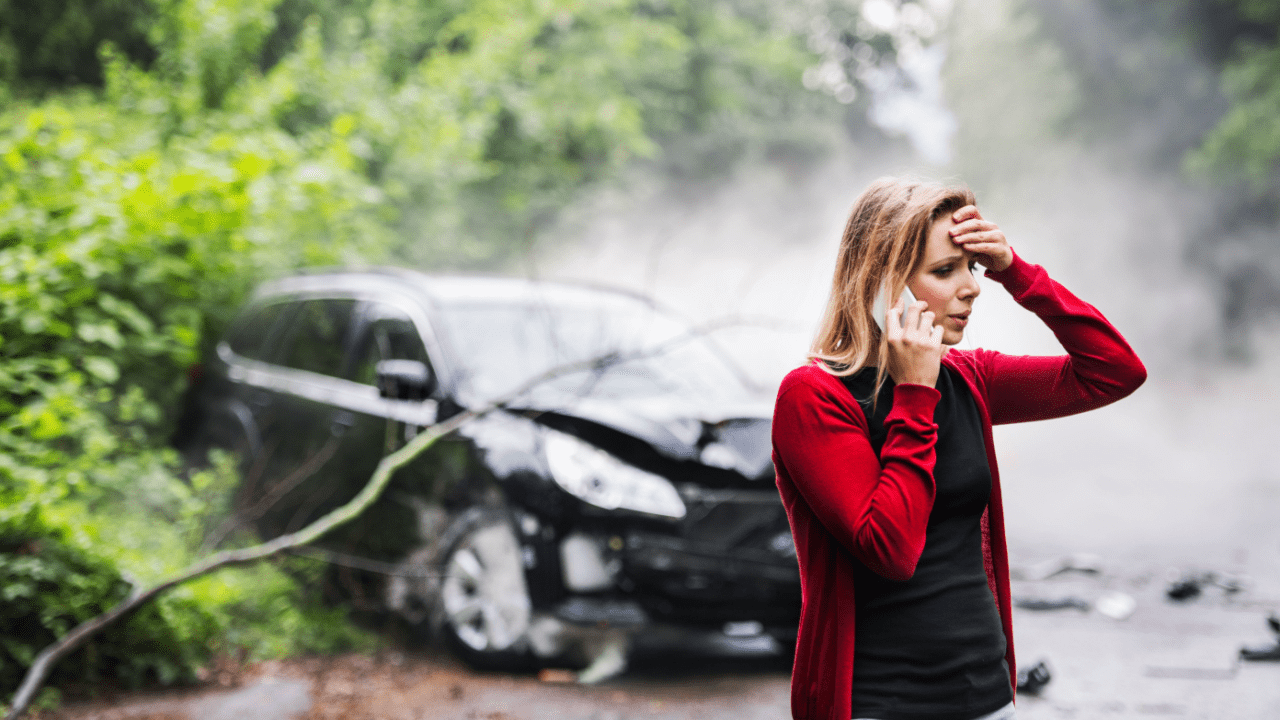 Woman on phone after car accident wondering should I call lawyer or insurance first
