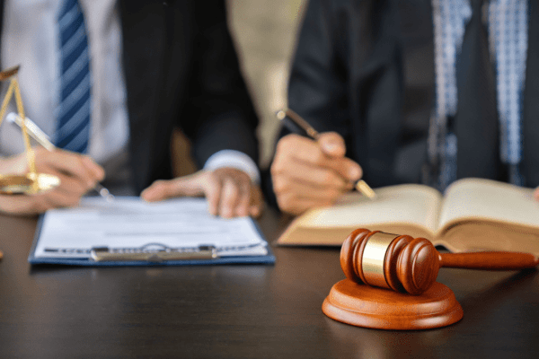 Attorney consultation discussing what not to tell the attorney during legal meeting with documents and gavel