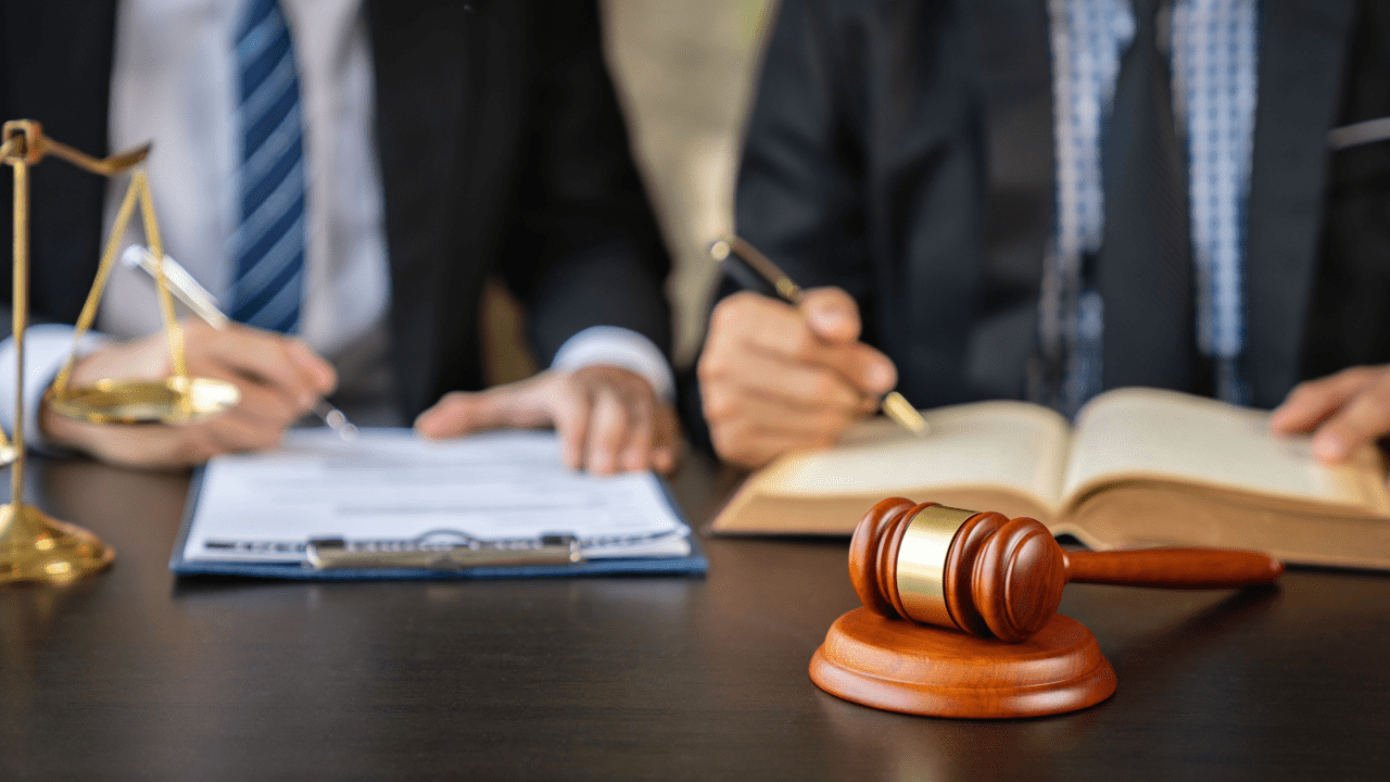 Attorney consultation discussing what not to tell the attorney during legal meeting with documents and gavel