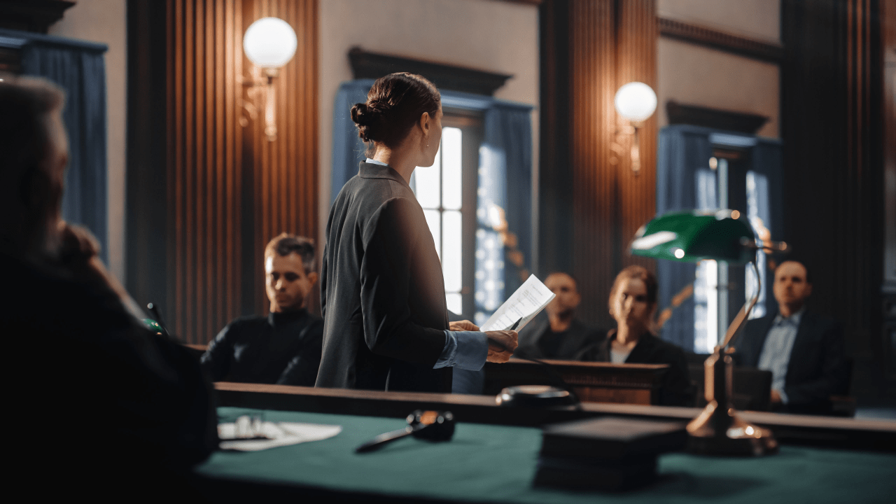 Woman standing in courtroom after car accident case wondering why do I have to go to court after a car accident