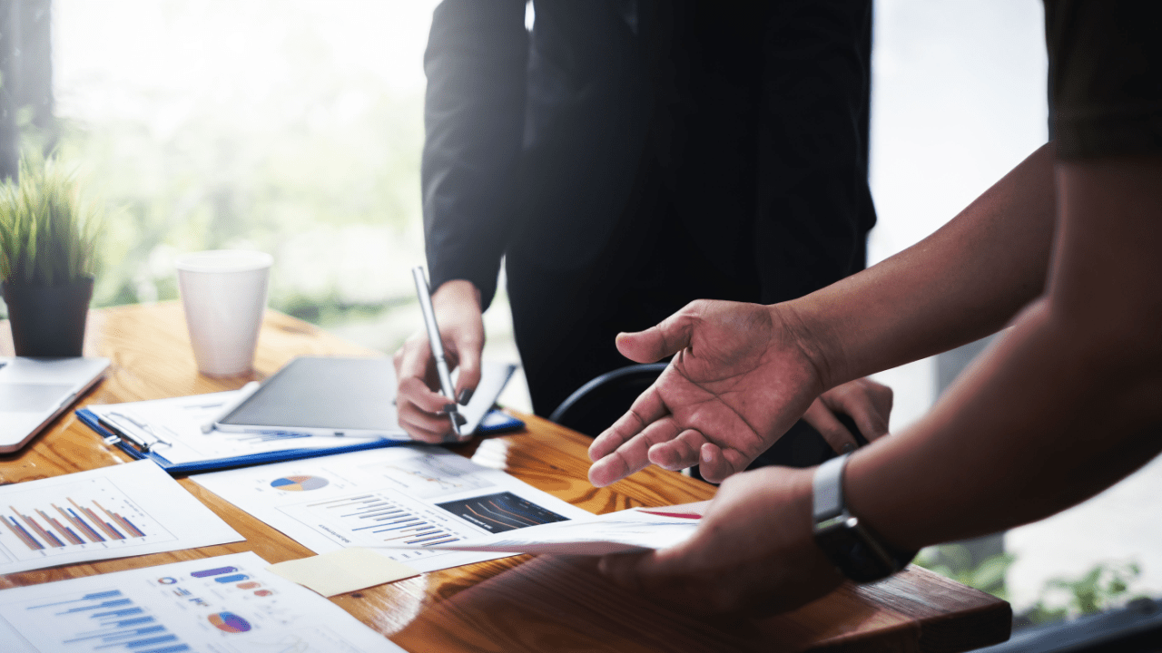 Business professionals discussing do truck accident lawyers work on contingency during consultation with financial charts and legal documents