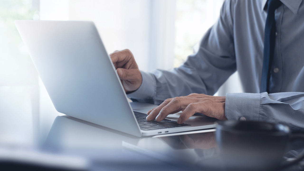 Professional researching what injuries pay the most in accident claims on laptop computer