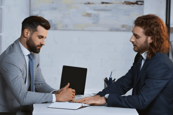 Professional typing on laptop researching how much can you get out of pain and suffering compensation