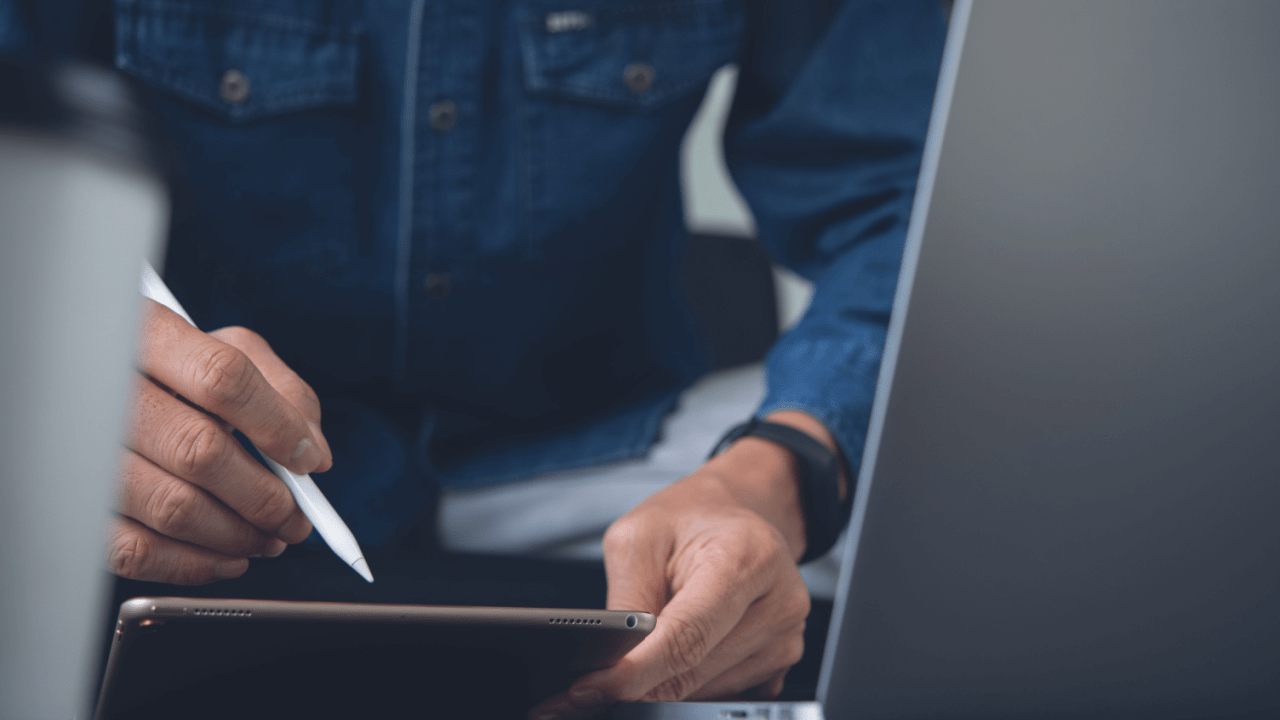 Professional using stylus on tablet to research how to get a big payout from a truck accident