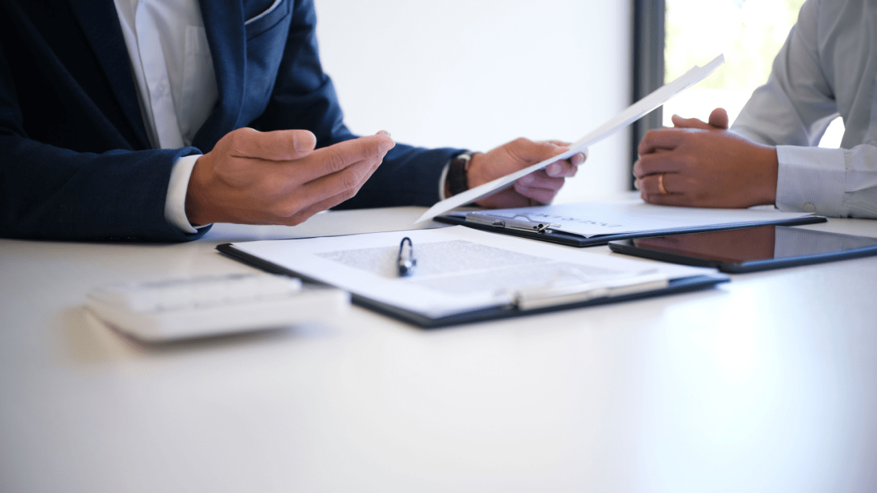 Legal consultation discussing compensation and damages in truck accidents with attorney and client reviewing documents