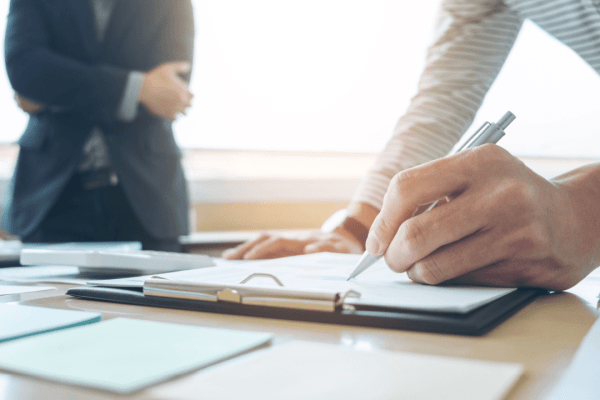 Professional attorney documenting what evidence helps an accident case during legal consultation and note-taking session