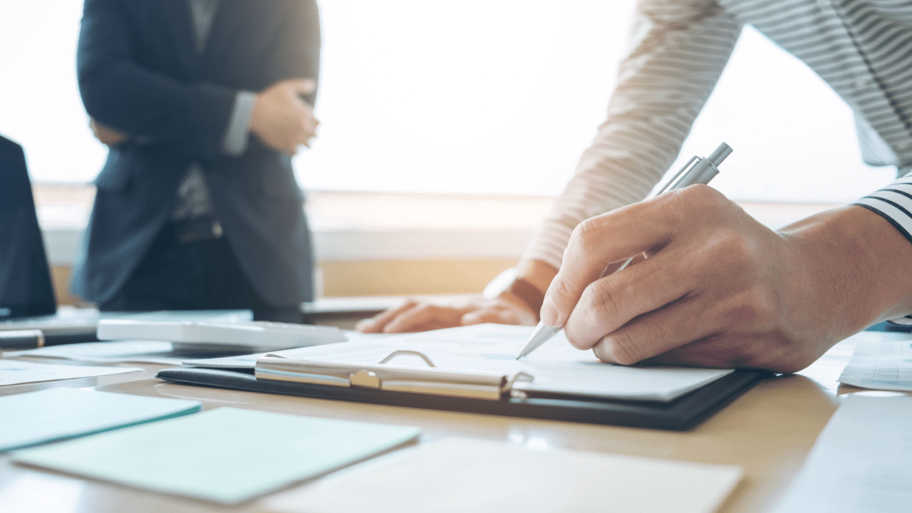 Professional attorney documenting what evidence helps an accident case during legal consultation and note-taking session