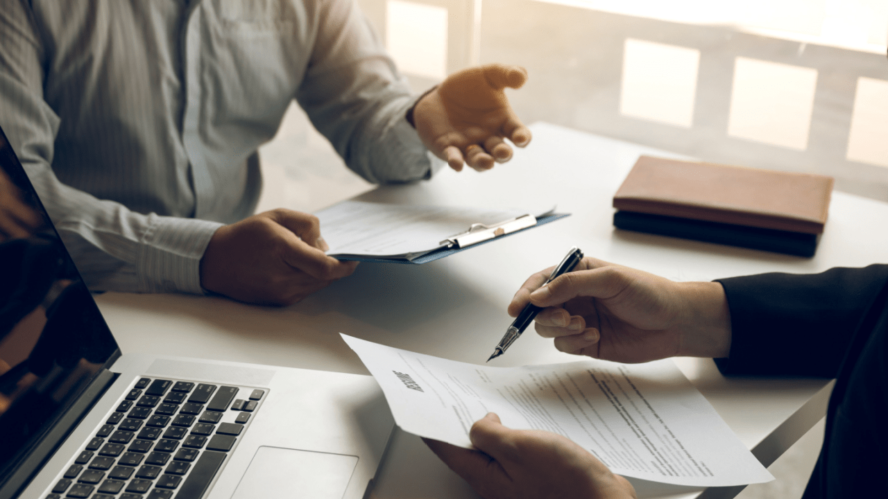 Professional meeting discussing when should you hire a truck accident lawyer with contract signing and legal documents