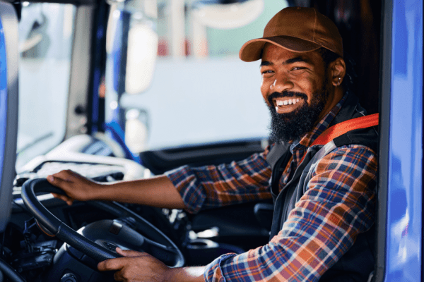 Professional truck driver in cab learning how many miles a day is a trucker allowed to drive under federal regulations
