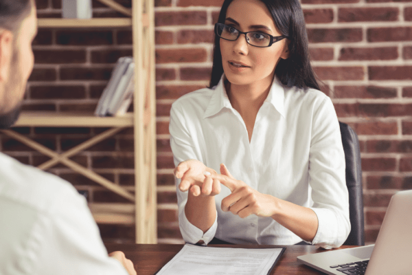 Female lawyer explaining how fast do you get paid after a settlement during client consultation meeting