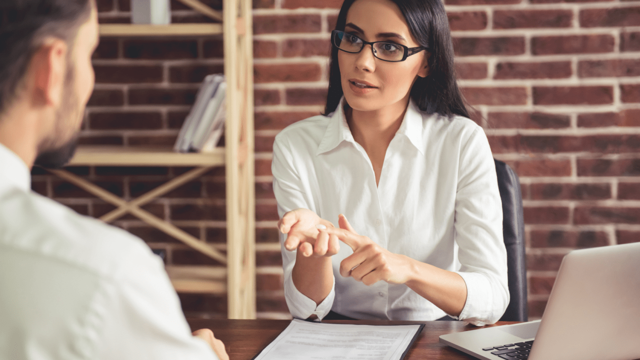 Female lawyer explaining how fast do you get paid after a settlement during client consultation meeting