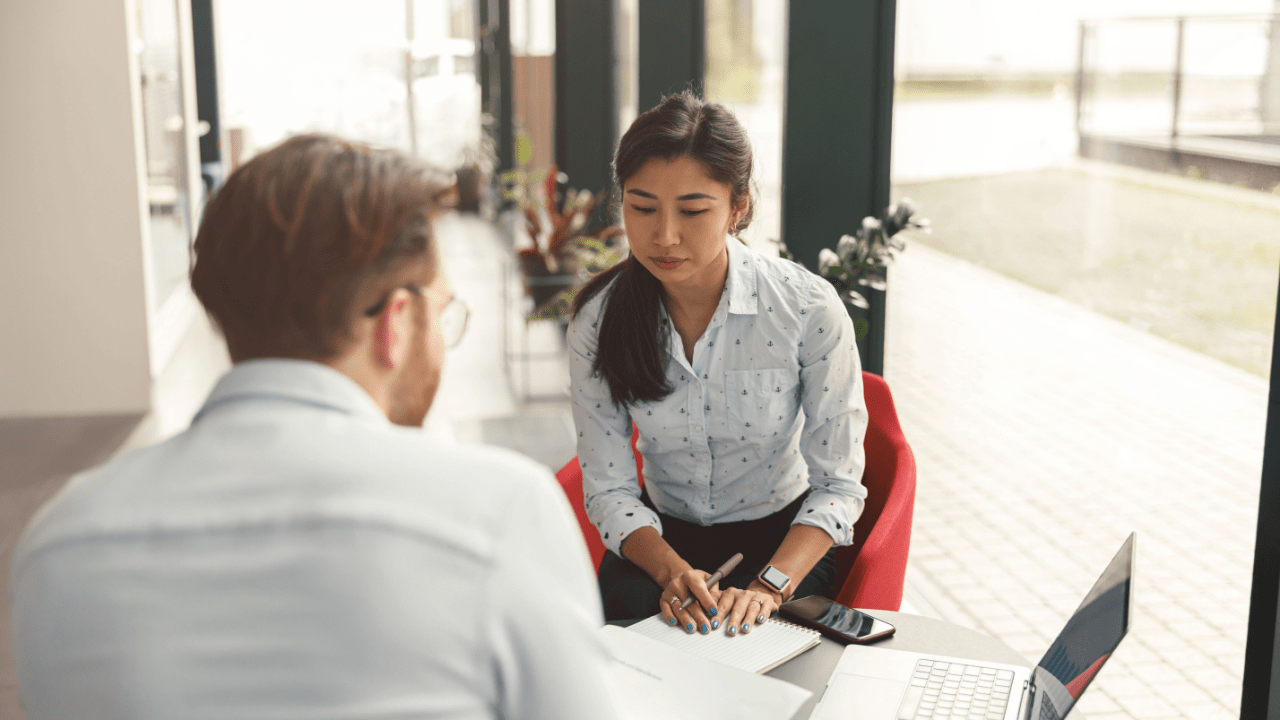 Professional attorney reviewing documents with client discussing what percentage of accidents go to court during legal consultation