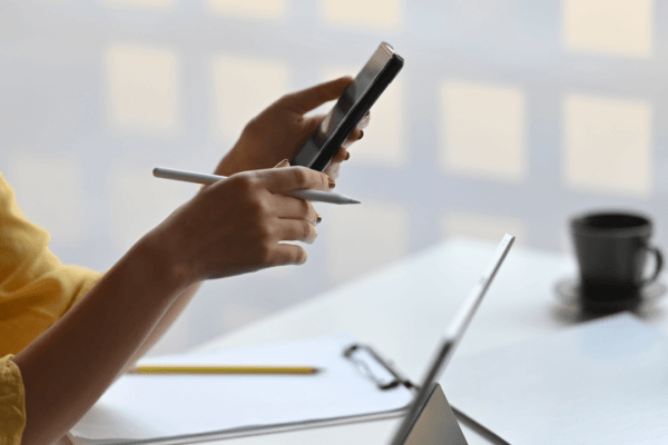 Mobile Research: Does Insurance Pay for Pain and Suffering - Person Investigating Claims on Smartphone