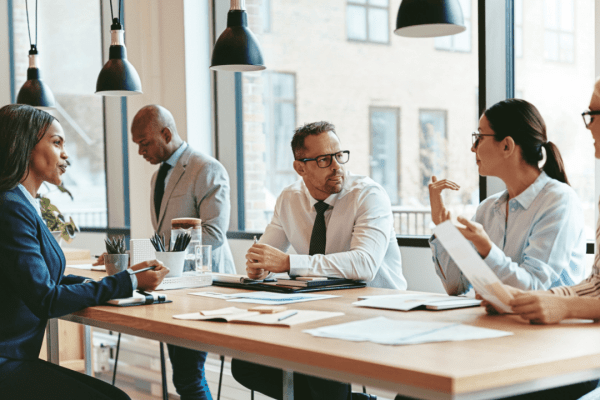 Professional attorneys discussing truck settlement timelines with clients during legal consultation meeting