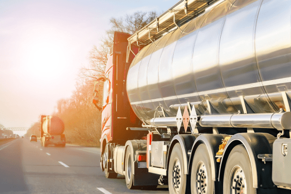 Commercial tanker truck hauling on highway demonstrating what are the DOT regulations for hauling compliance