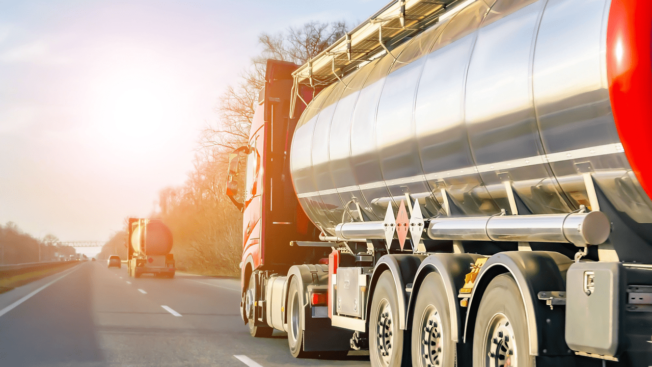 Commercial tanker truck hauling on highway demonstrating what are the DOT regulations for hauling compliance