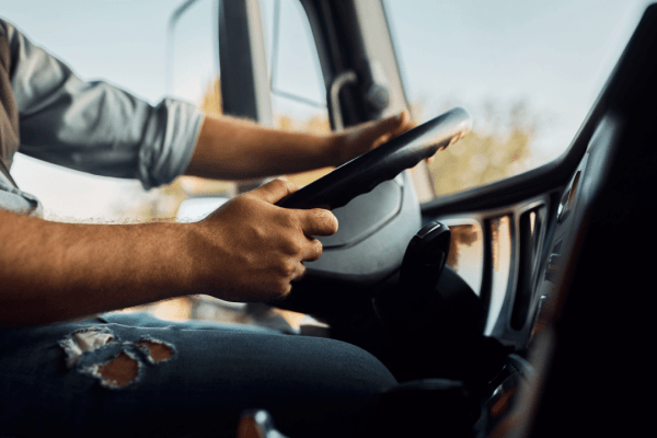Truck driver hands on steering wheel understanding what is cabotage in trucking regulations