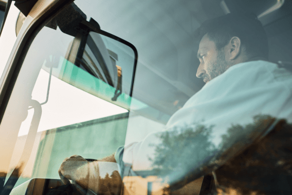 Truck driver in commercial vehicle cab learning what is considered a DOT incident