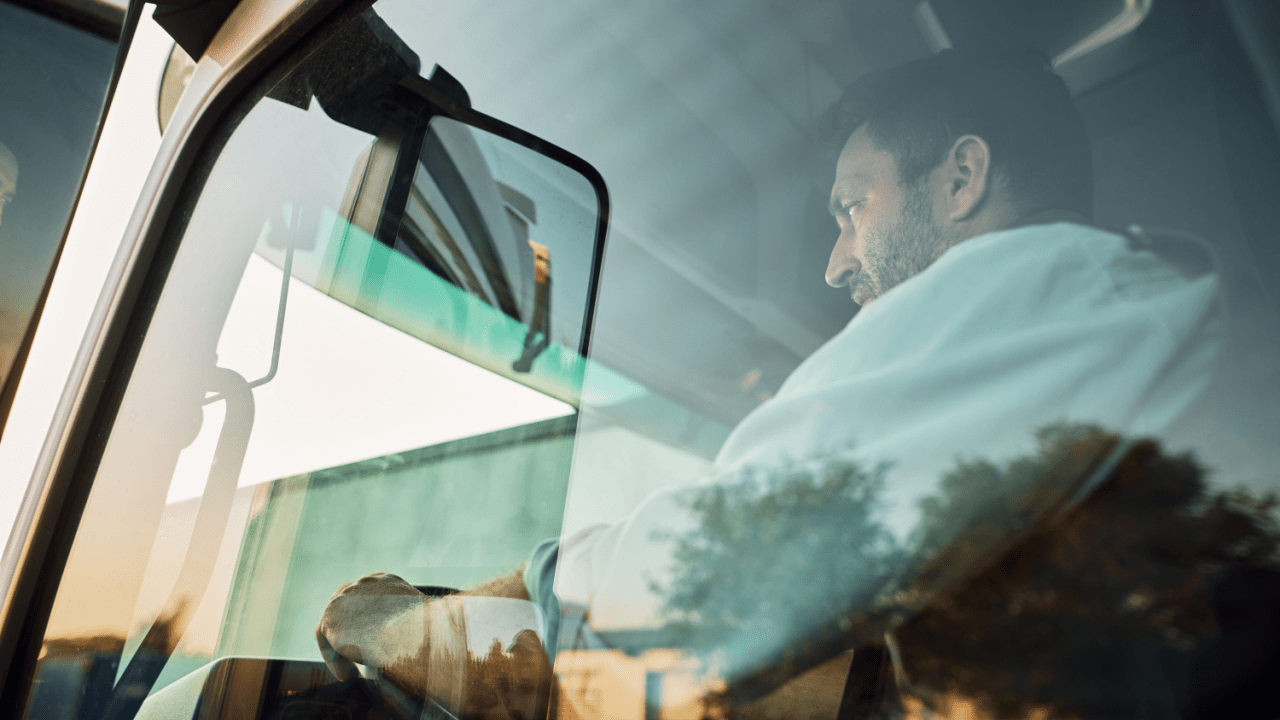 Truck driver in commercial vehicle cab learning what is considered a DOT incident