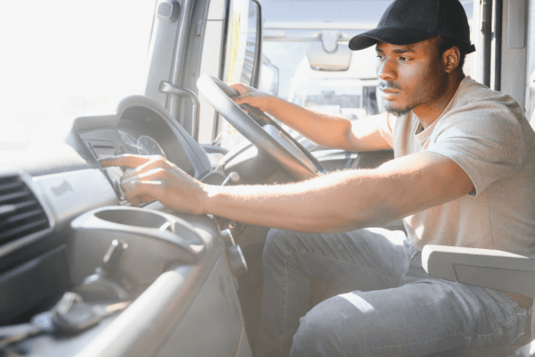 Truck driver at steering wheel learning what is a truck restriction for commercial vehicles