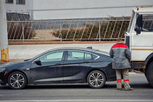 Evaluating truck accident settlement offers begins with damage assessment by responder examining collision between sedan and commercial truck