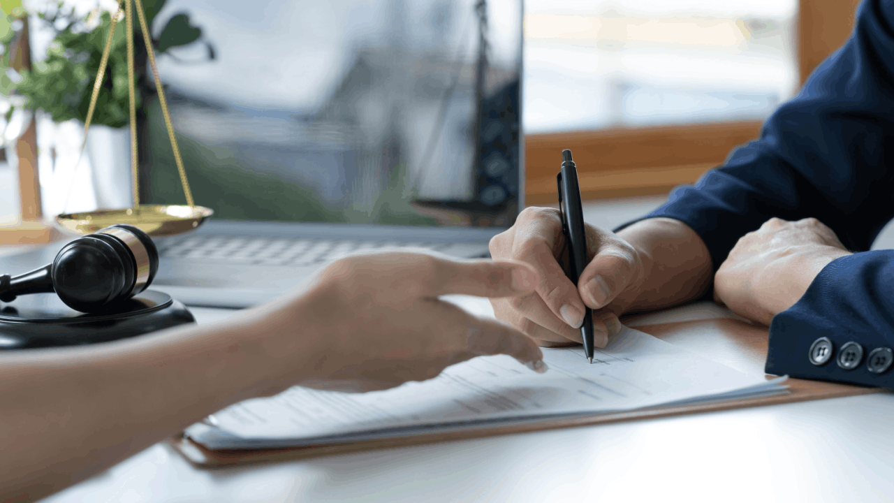 Hardest injuries to prove in truck accident cases shown through attorney documenting evidence with legal paperwork and scales of justice